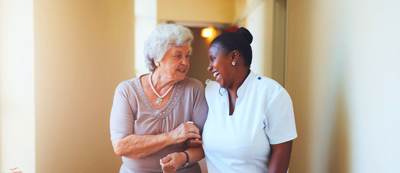 senior woman and caregiver talking