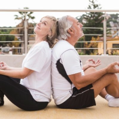 happy old couple doing yoga