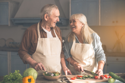 old couple having happy moment while preparing foods